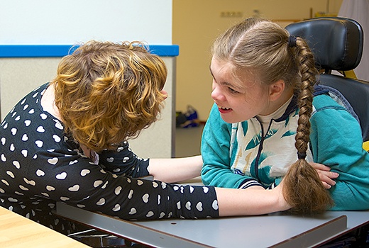 adult talking to a child with special needs