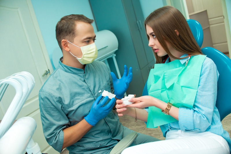 Patient talking to the dentist about dental implant surgery