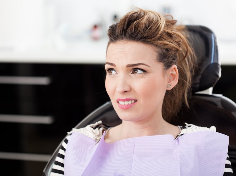 A worried woman about to get cosmetic dentistry